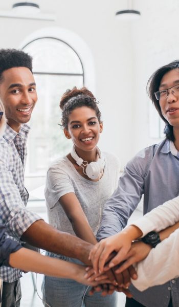 handsome-african-guy-with-happy-face-expression-supporting-his-friends-before-conference-indoor-portrait-work-team-young-international-specialists-preparing-meeting-with-chief_197531-3781